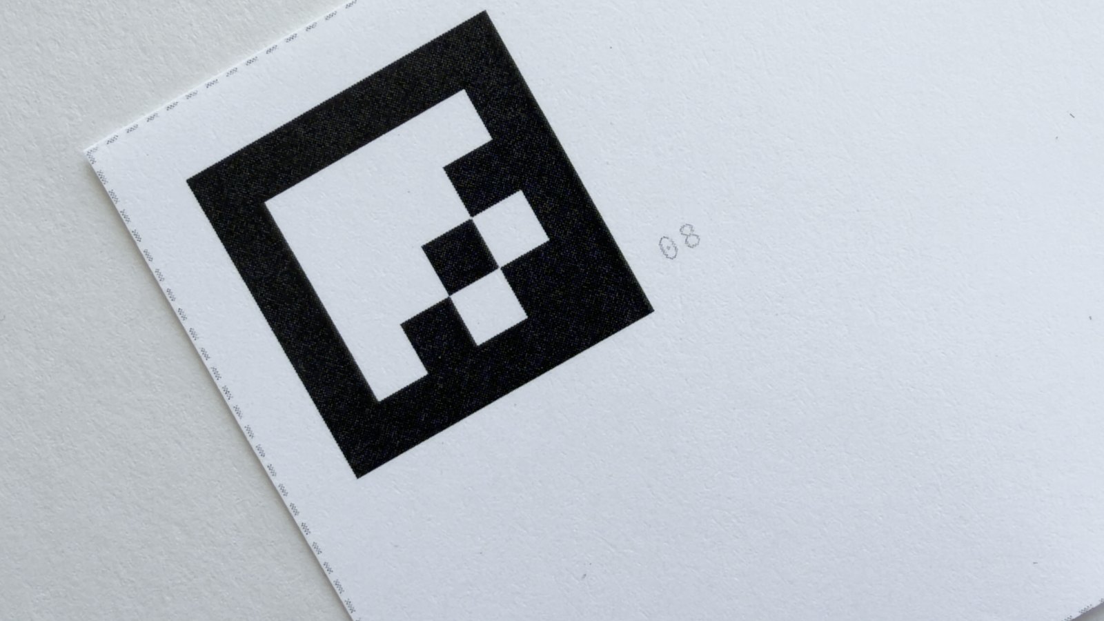 Close-up of a printed marker on a card, trim marks visible.